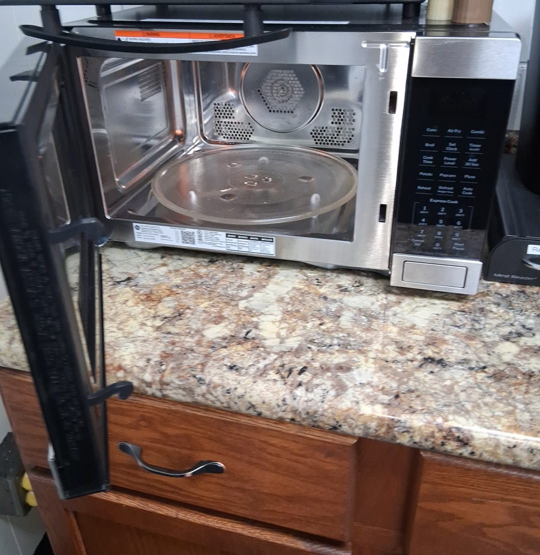 Break-area counter with a cleaned microwave interior on a granite counter