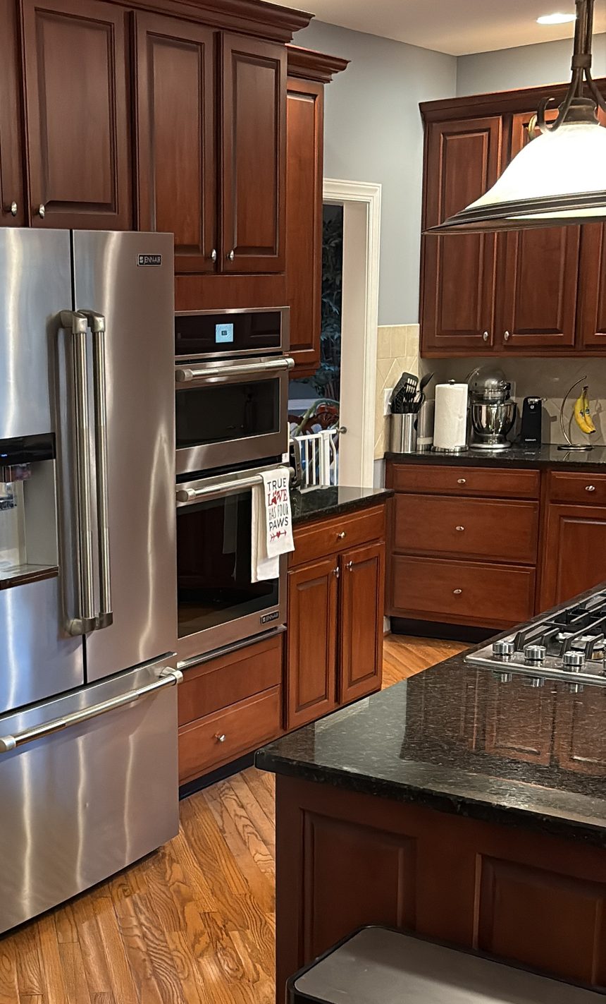Cabinet fronts on a standard clean Wood cabinet fronts, drawer fronts and granite counters in a cleaned kitchen